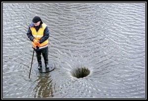 water draining down manhole