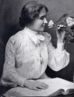 young Helen Keller smelling a flower